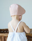 Back of pink bonnet on baby model.