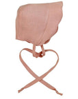Shell pink linen scallop bonnet with adjustable ties, designed for sun protection and comfort