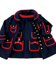 Little Goodall Girls Pocket Paddington Bow Dress and matching navy wool coat with red trim, gold buttons, and playful embroidered details