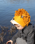 Child wearing a cozy felt lion hat with a sherpa lining and yarn mane, designed for warmth and imaginative play outdoors.