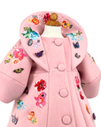 Girls' pink wool coat with Rainbow Bloom floral embroidery and colorful butterfly appliqués, featuring a statement collar and vintage-inspired button detail