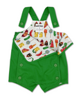 Toddler wearing a green Hungry Caterpillar romper with embroidery, layered over a food print shirt, featuring adjustable straps and side buttons