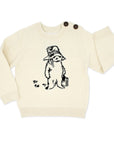 Ivory cotton knit Paddington Bear sweater for kids featuring classic Peggy Fortnum illustration on the front. Unisex and machine washable.
