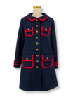 Ladies' deep blue wool coat with bold red trim, gold-tone buttons, and four pockets. A-line design with exclusive Paddington print lining