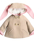 Beige wool bunny coat with pink-lined ears, faux fur hood, and double-breasted buttons