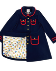 Womens navy blue wool coat with gold-tone buttons, red trim, and Paddington print satin lining. A classic A-line design