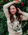 Adult Paddington Bear Sweater in ivory cotton knit, unisex classic fit, featuring Peggy Fortnum’s illustration, styled over a striped shirt.