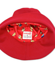 A close-up of the Little Goodall Paddington Bear red bucket hat, showcasing its playful illustrated lining with Paddington Bear prints