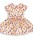 Vintage-style pink girls' dress with red piping, belted waist, and full skirt—crafted from soft cotton for timeless charm and comfort