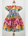 Video showcasing the full detailed print of the Rainbow Bloom Dress, featuring vibrant floral and butterfly patterns on soft, flowing fabric