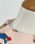 Children’s dress with classic Paddington Bear print, red piping, and matching belt. Front and back views shown."
