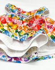 Close-up of the Rainbow Bloom Dress showcasing its full twirl effect, layered skirt lining, and vibrant floral and butterfly print.
