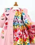 Pink wool girls' coat with embroidered flowers, butterfly appliqués, and vibrant floral lining, shown over a matching dress
