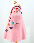 Side view of Rainbow Bloom Girls Coat in pink wool with floral embroidery and 3D butterfly details