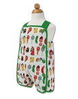 Side view of a reversible Hungry Caterpillar toddler romper, on form showcasing colorful food-themed fabric.