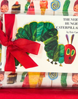 The Very Hungry Caterpillar Board Book wrapped with a red ribbon, paired with a matching printed fabric gift set