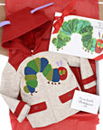 The Very Hungry Caterpillar hardcover book paired with a matching hooded coat in a gift box with red tissue paper and a handwritten note