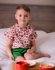 Child wearing a short-sleeve button-up strawberry print shirt from The Very Hungry Caterpillar collection, made of breathable cotton