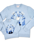 Matching ladies’ and girls’ Willa Heart blue dog sweaters with intarsia knit dog and dragon motif