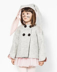 Model wearing grey bunny coat with hood up and floppy bunny ear pink lining visible.