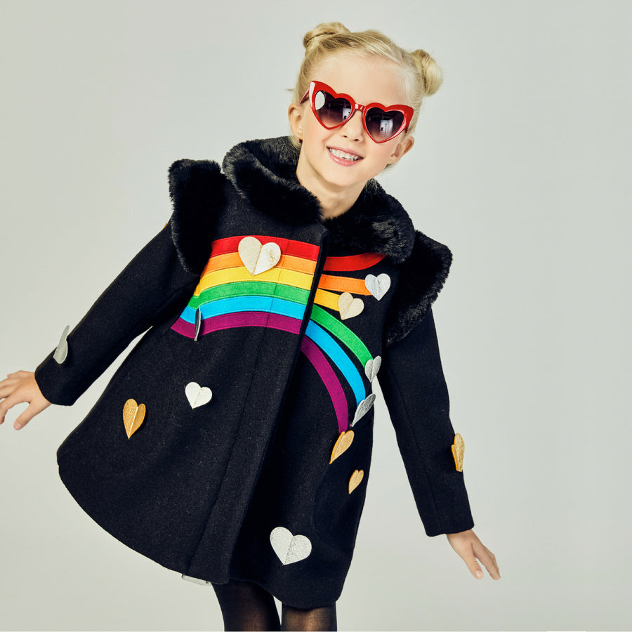 Model showing front of black coat, dissplaying the full rainbow with silver and gold hearts.