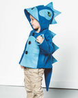 kid the Blithe Blue Dinosaur Coat by Little Goodall, a cozy wool blend jacket with a hood, ridged back, and playful tail.