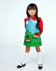 Classic children’s dress with a fairy tale village motif