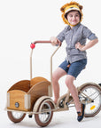 Child wearing a Ferocious Felt Lion Hat while riding a tricycle, showcasing the cozy wool blend and fun design.