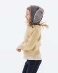 Child modeling the Flopsy Bunny Hat in mushroom brown wool with gray ears, soft fleece lining, and a secure chin strap