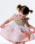 Toddler twirling in Little Goodall Pink Gingham Bunny Love Dress with embroidered bunny face, floppy ears, and dangling carrot accents.