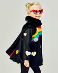 Girls' black wool coat with rainbow appliqué, gold and silver hearts, faux fur collar, and red pleat detail