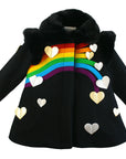 Black dress coat with a rainbow across the chest, hearts at the rainbow's end and sides, plus a black faux fur collar and structured shoulder pads