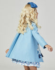 back view of girl blue wool coat with embroidered dogs, tufted pillows, and tassels, featuring Willa Heart artwork. Lined with satin lattice print