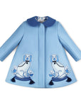 Light blue wool girls' coat with embroidered Staffordshire dog motifs, tasseled pillows, and a satin lattice lining, from Willa Heart collaboration