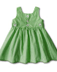 Back view of a green gingham sundress featuring button details, scalloped hem, and decorative side buttons.