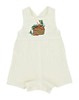 Ivory linen romper with embroidered bunny in a basket, adjustable straps, and button closures. Gender-neutral baby and toddler outfit