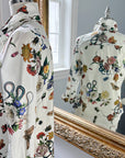 Side and back view of the Ivory Grand Botanical Ladies Shirt with a floral, butterfly, and beetle print on cotton sateen, featuring a structured collar