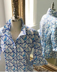 Ladies' classic button-down shirt in Willa Heart blue and white dog print on a mannequin, with a mirror reflection of the back.