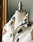 Close-up of botanical print shirt collar on mannequin, featuring floral and insect design