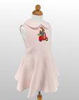 Side view of Linen Scooter Bunny Dress on mannequin, featuring embroidered bunny on scooter and flared skirt.