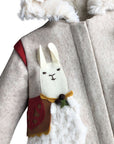 Close-up of the Little Goodall Lucky Llama Coat, showcasing a detailed felt llama appliqué with a faux fur body, red saddle, and embroidered face