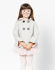 Girl wears a grey bunny coat with pink-lined cuffs, a cozy hood, and double-breasted buttons, styled with a pink tutu and tights.