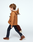 Child walking in a brown wool fox coat with a hood featuring fox ears and a detachable fox tail