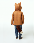 Child facing away, wearing a brown wool fox coat with pointed hood ears and a detachable fox tail.