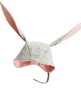 Grey bunny hat with long ears, made of Merino wool in light heather grey, featuring a chin strap and pink-lined ears.