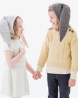 Child wearing the Luxe Grey Bunny Hat, featuring floppy ears, an adjustable velcro chin strap, and a soft fleece lining
