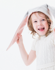Child wearing Little Goodall Luxe Grey Bunny Hat, featuring floppy bunny ears and a cozy light grey Merino wool design.