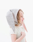 Close-up of a child wearing the Little Goodall Luxe Grey Bunny Hat, showing soft grey fabric with pink-lined floppy ears