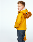 Boy wearing Little Goodall Luxe Lion Coat in gold wool, showing lion hood with mane, ears, and tail in a side view. Cozy and playful kids' jacket