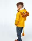Boy wearing Little Goodall Luxe Lion Coat in gold wool, showing back view with lion hood, mane, and tail. Playful and cozy kids' jacket